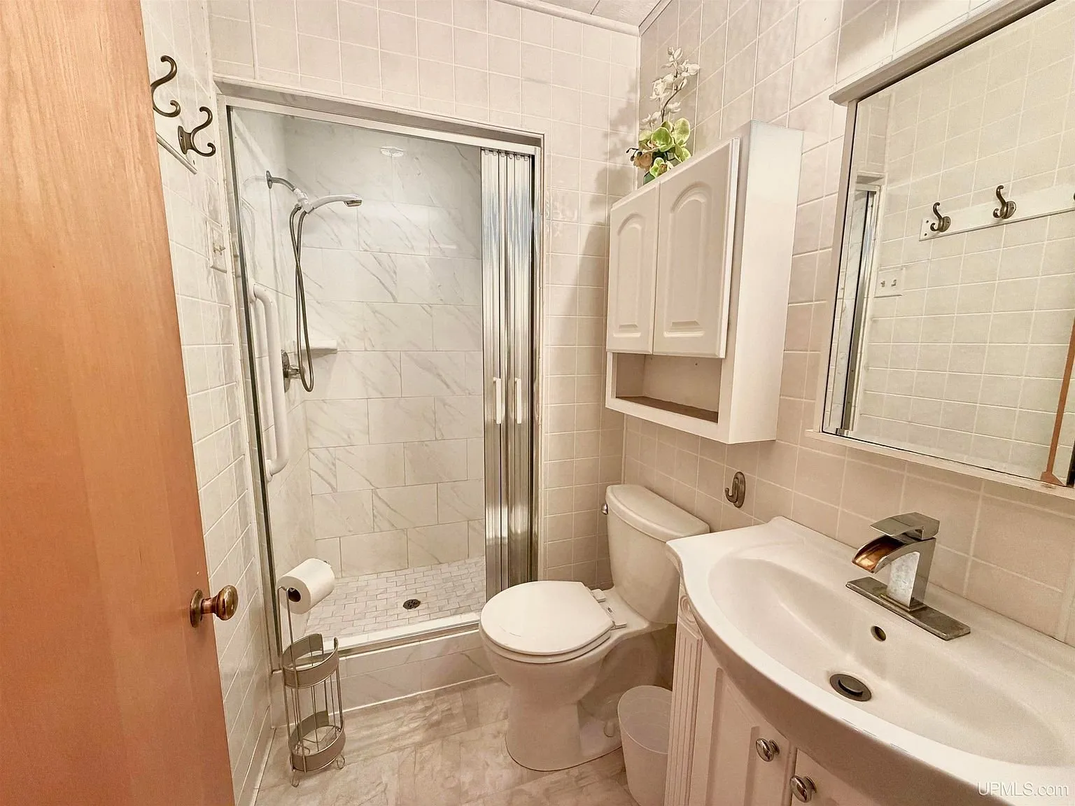 The full bath with the shower stall, toilet and vanity