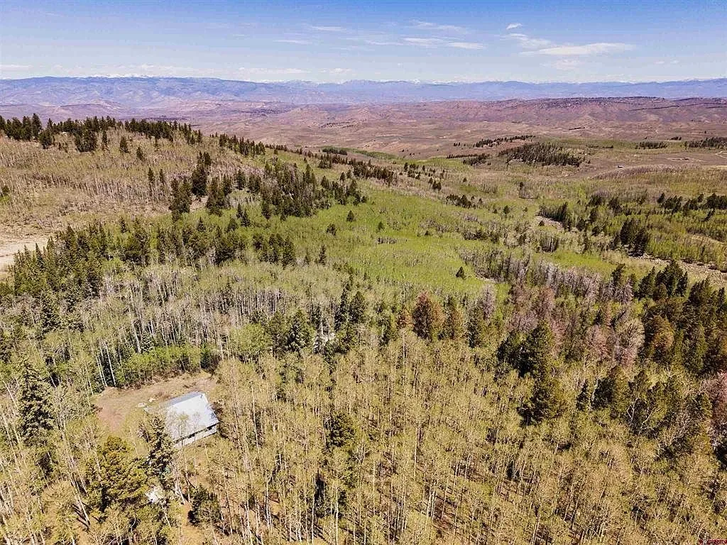 The parcel from the air with the aspens, the meadows and the valley beyond
