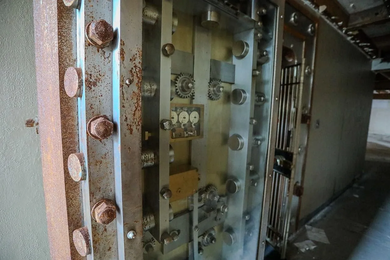The vault door's bolts and hinges, rusting