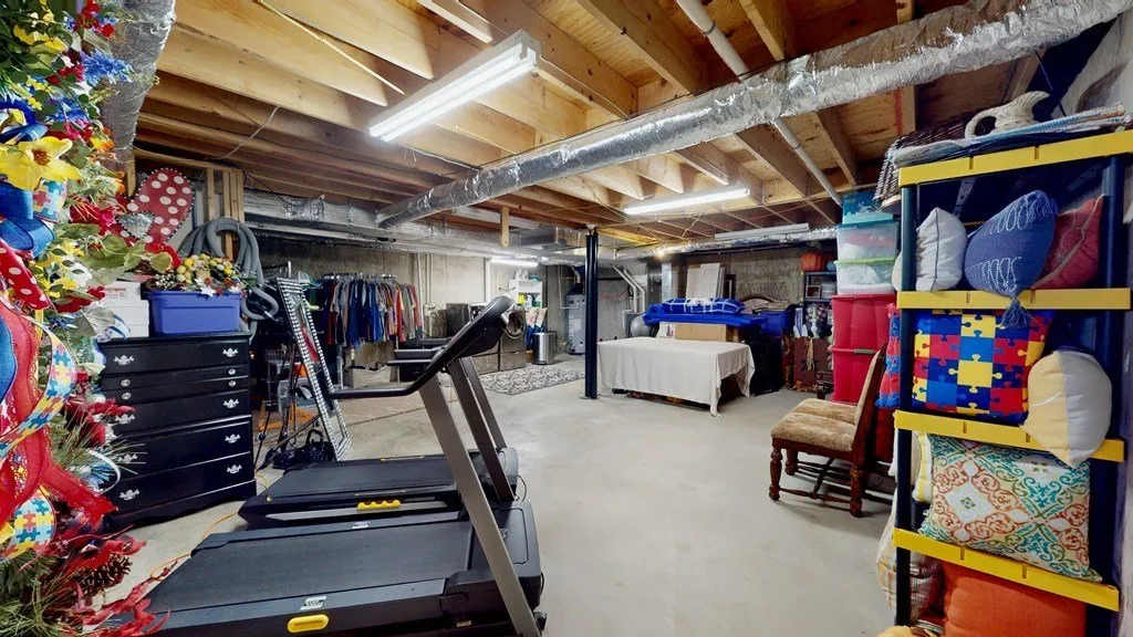 The basement gym with a treadmill and climbing wall