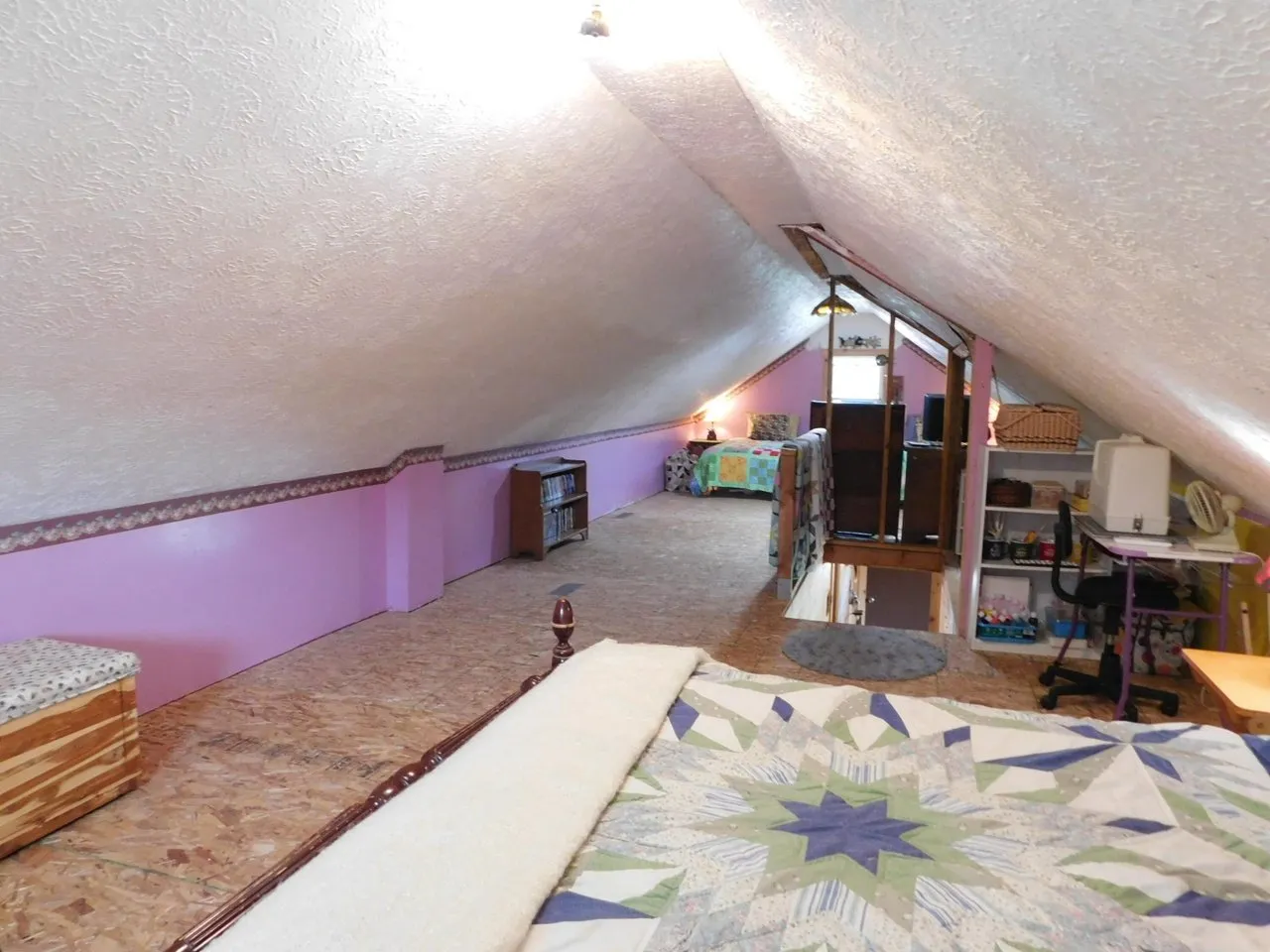 The loft floor and rug looking toward the stairs