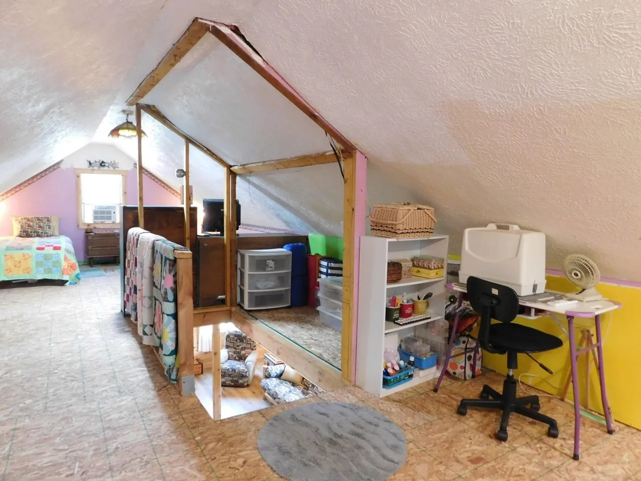 The loft from the stair head, shelves and a desk along the wall