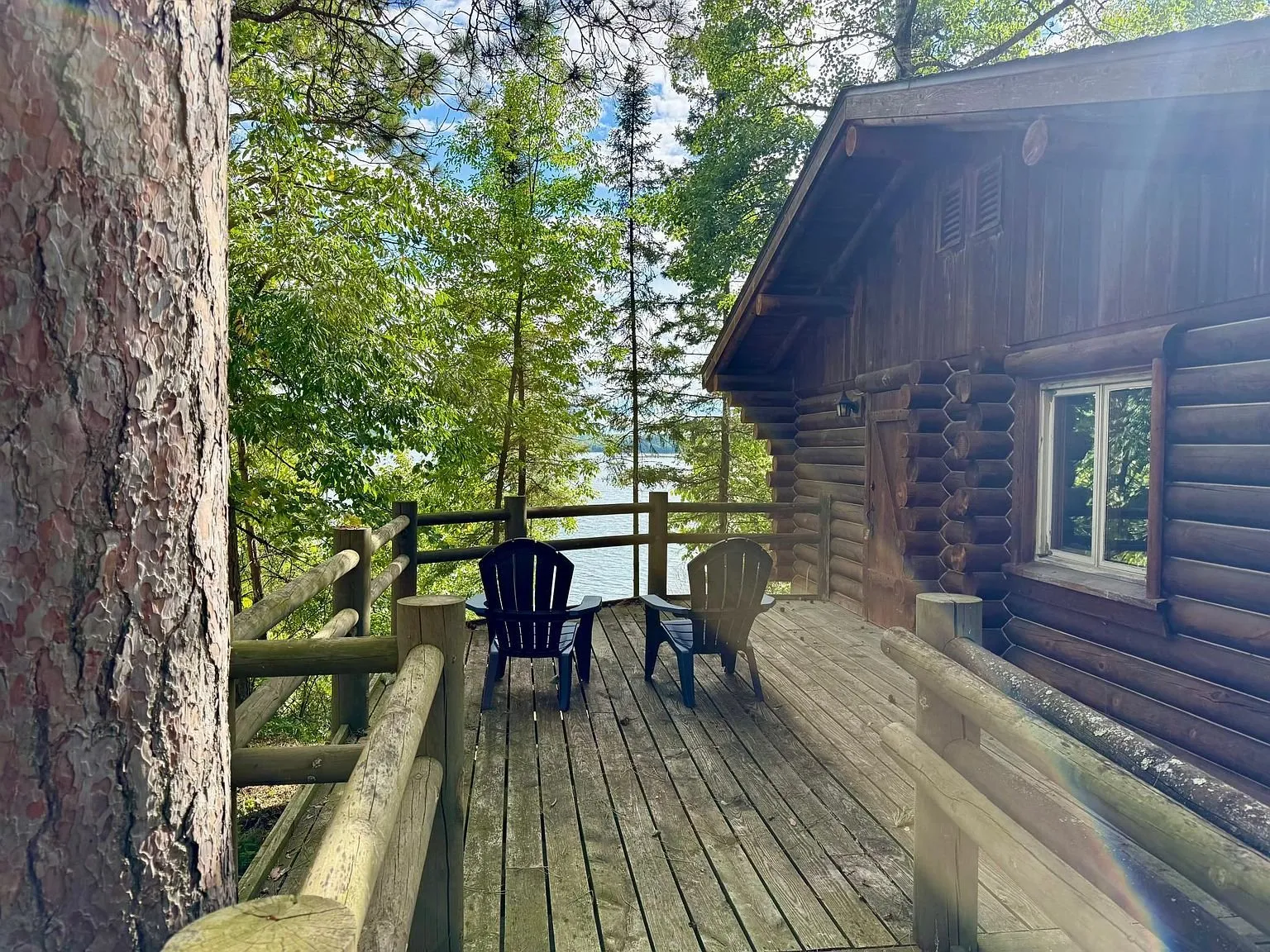 The deck with the chairs and the door of the cabin