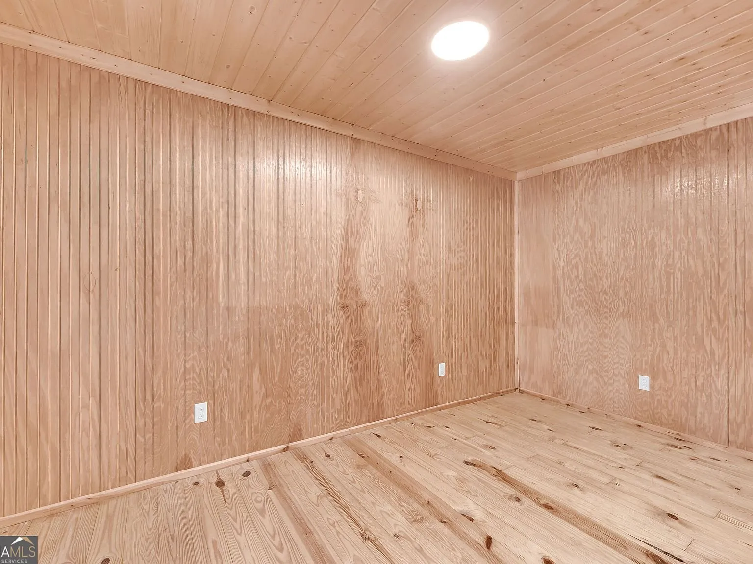 A glass-enclosed shower and vanity in one of the updated bathrooms