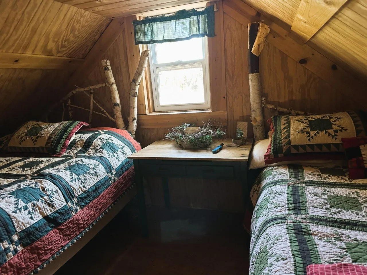 A bed in the sleeping loft under the window
