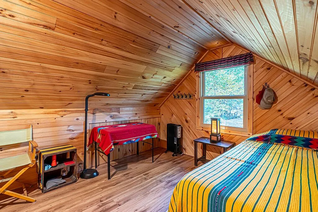 The loft bedroom's window seating area and stairway landing