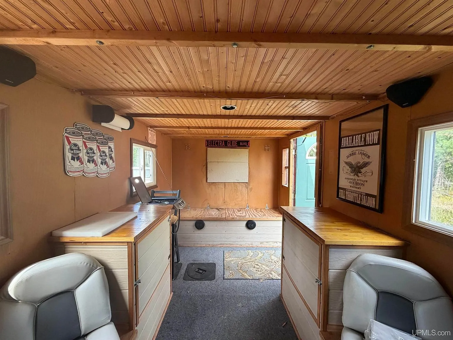 Inside the red shack with the pine ceiling, the counters and the two chairs