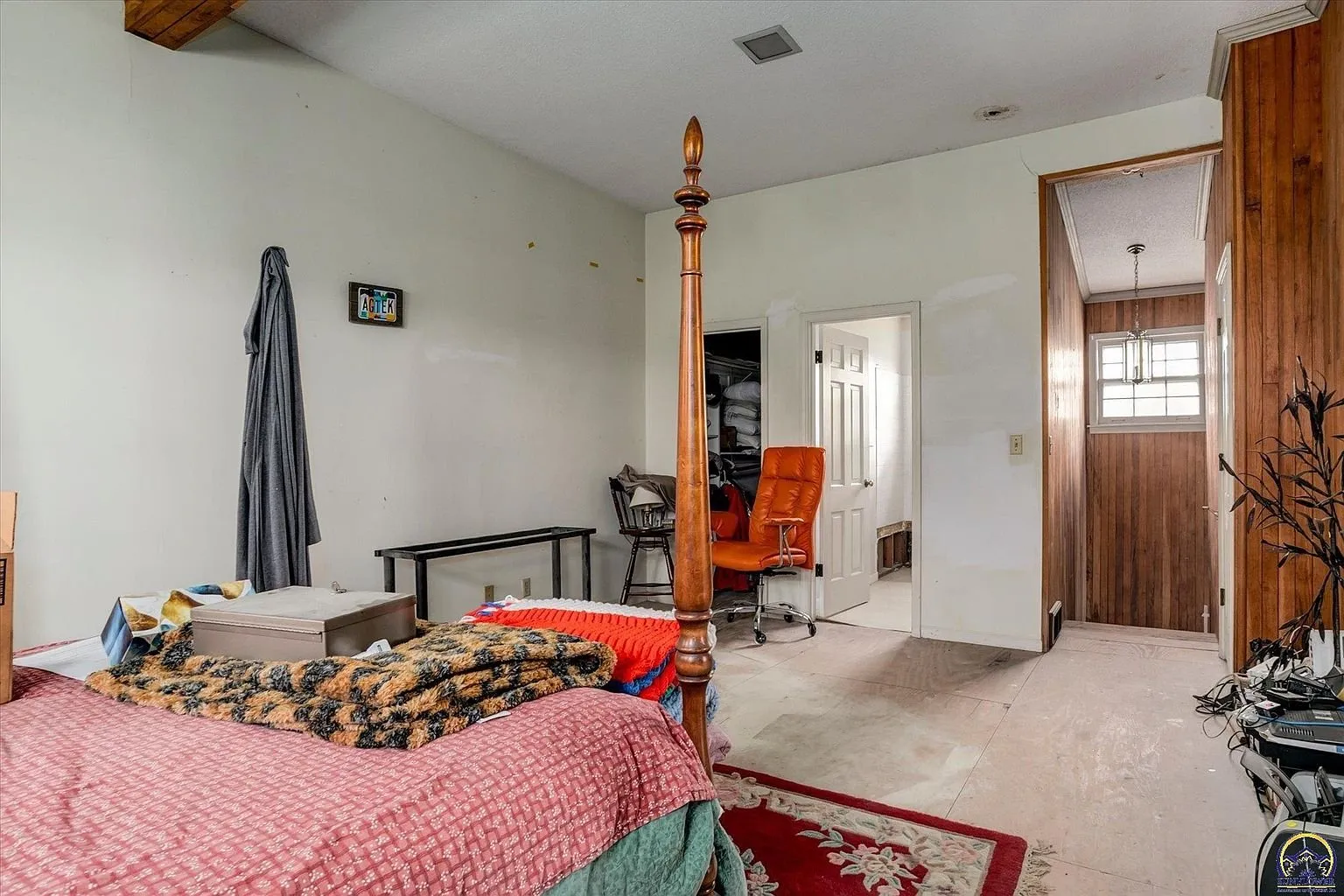 The second bedroom with the four-poster bed and the doorway