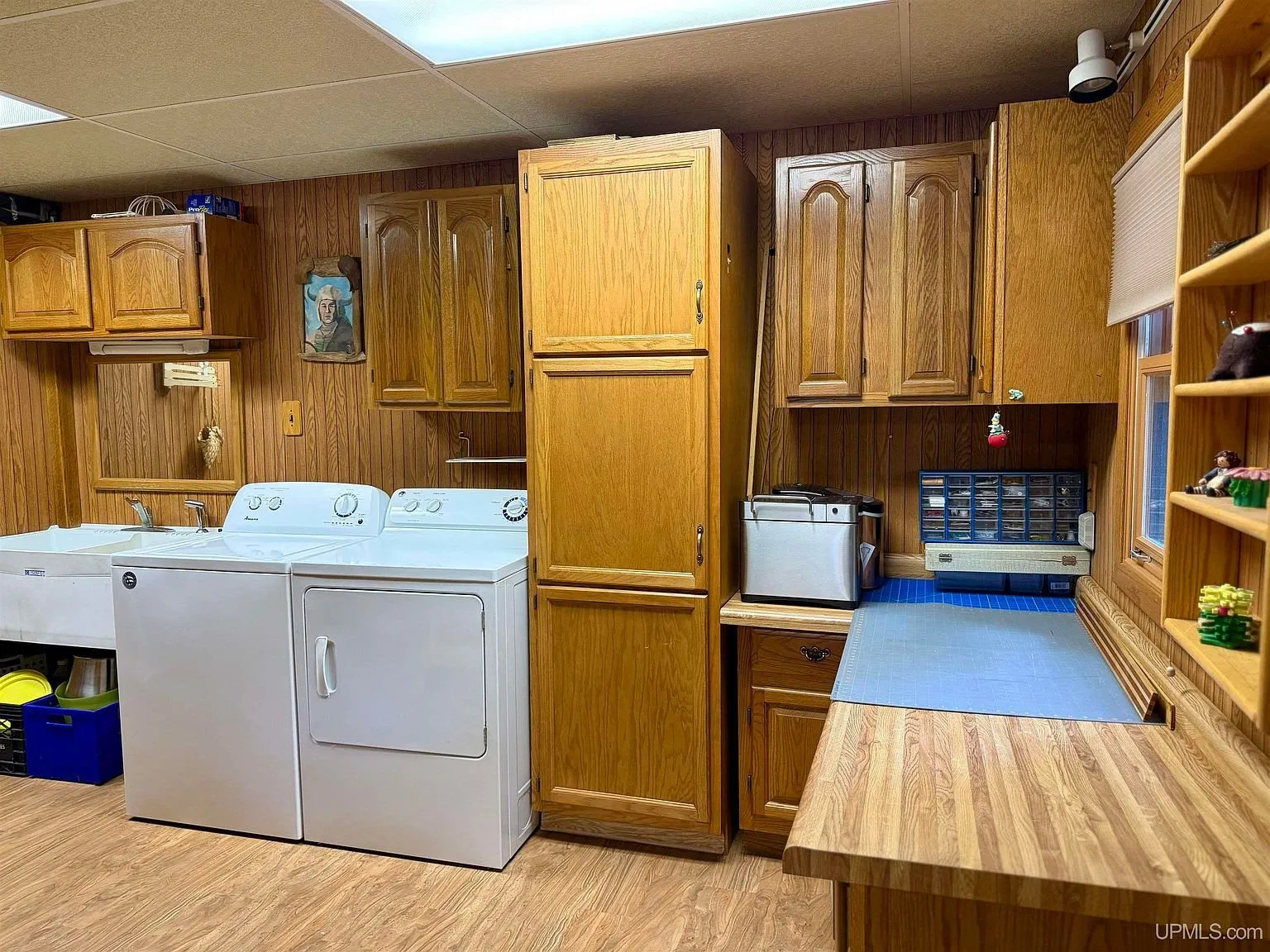 The laundry room with the washer, dryer and cabinets