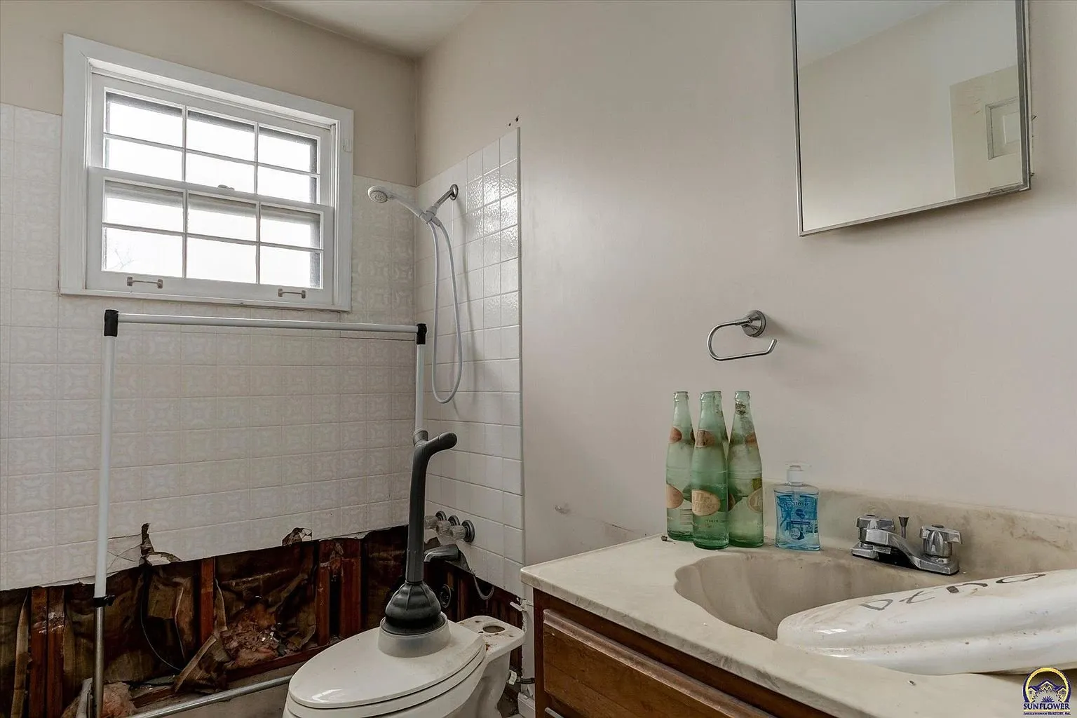The bathroom off the second bedroom with the shower and the vanity