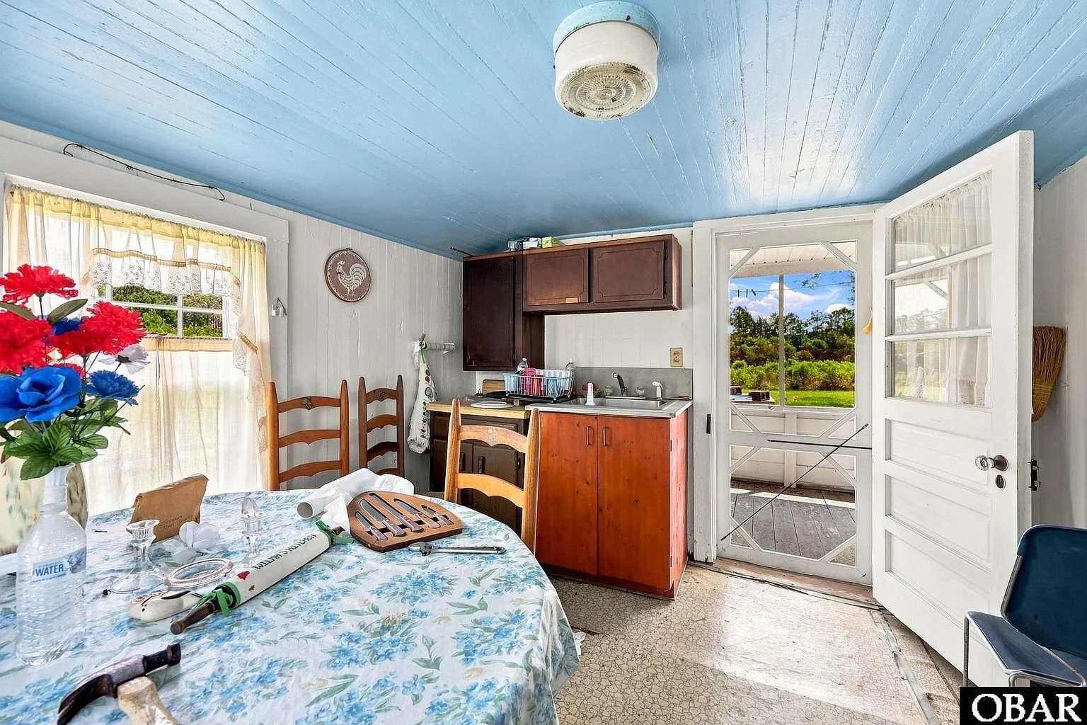 The kitchen door open to the screened porch