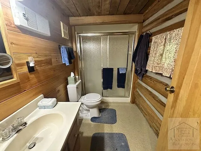 The bathroom with sink, toilet and shower stall
