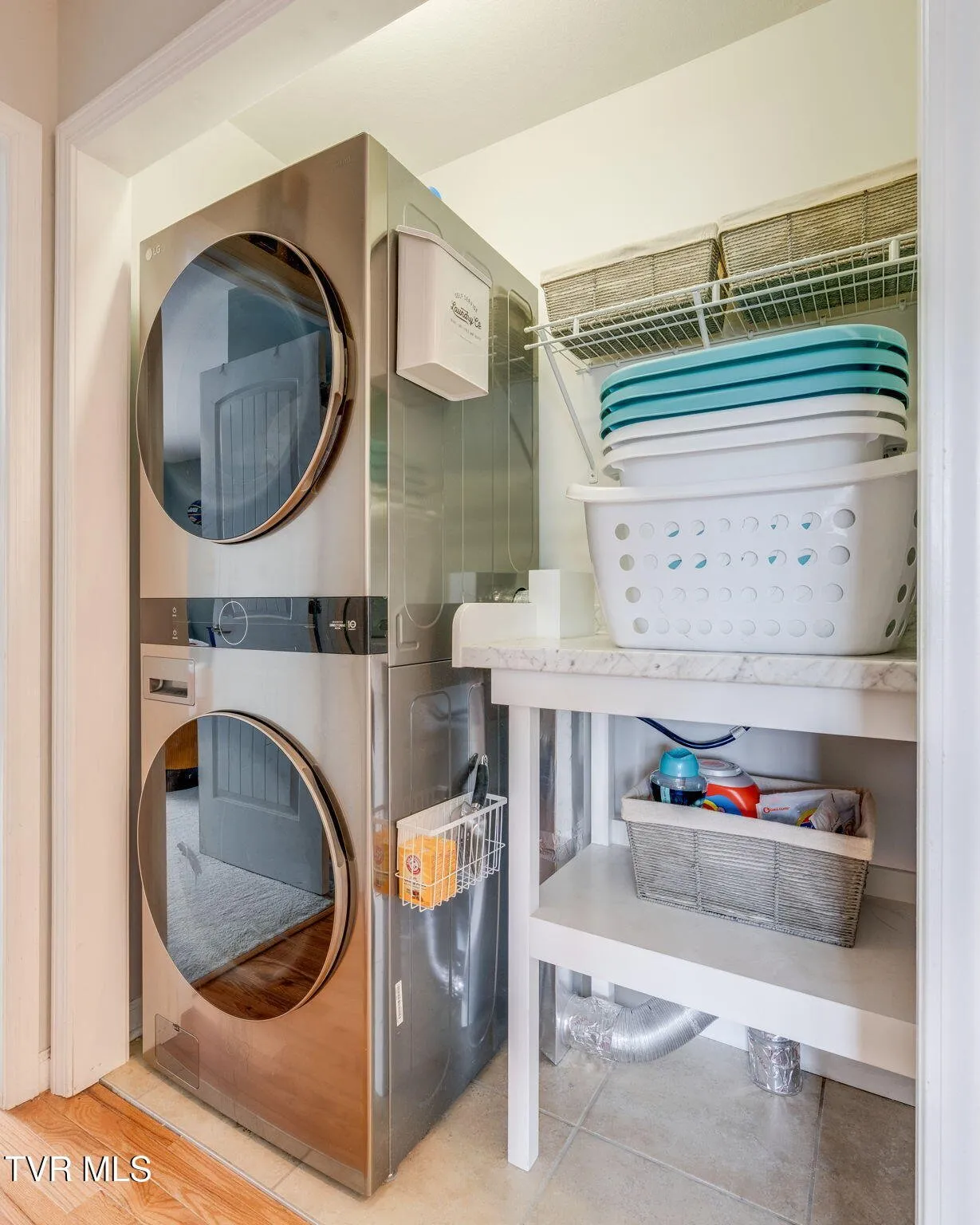 The upstairs laundry area with the stacked washer and dryer in a closet
