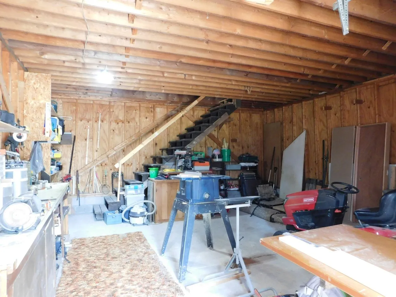 The garage upper level with tools and open framing