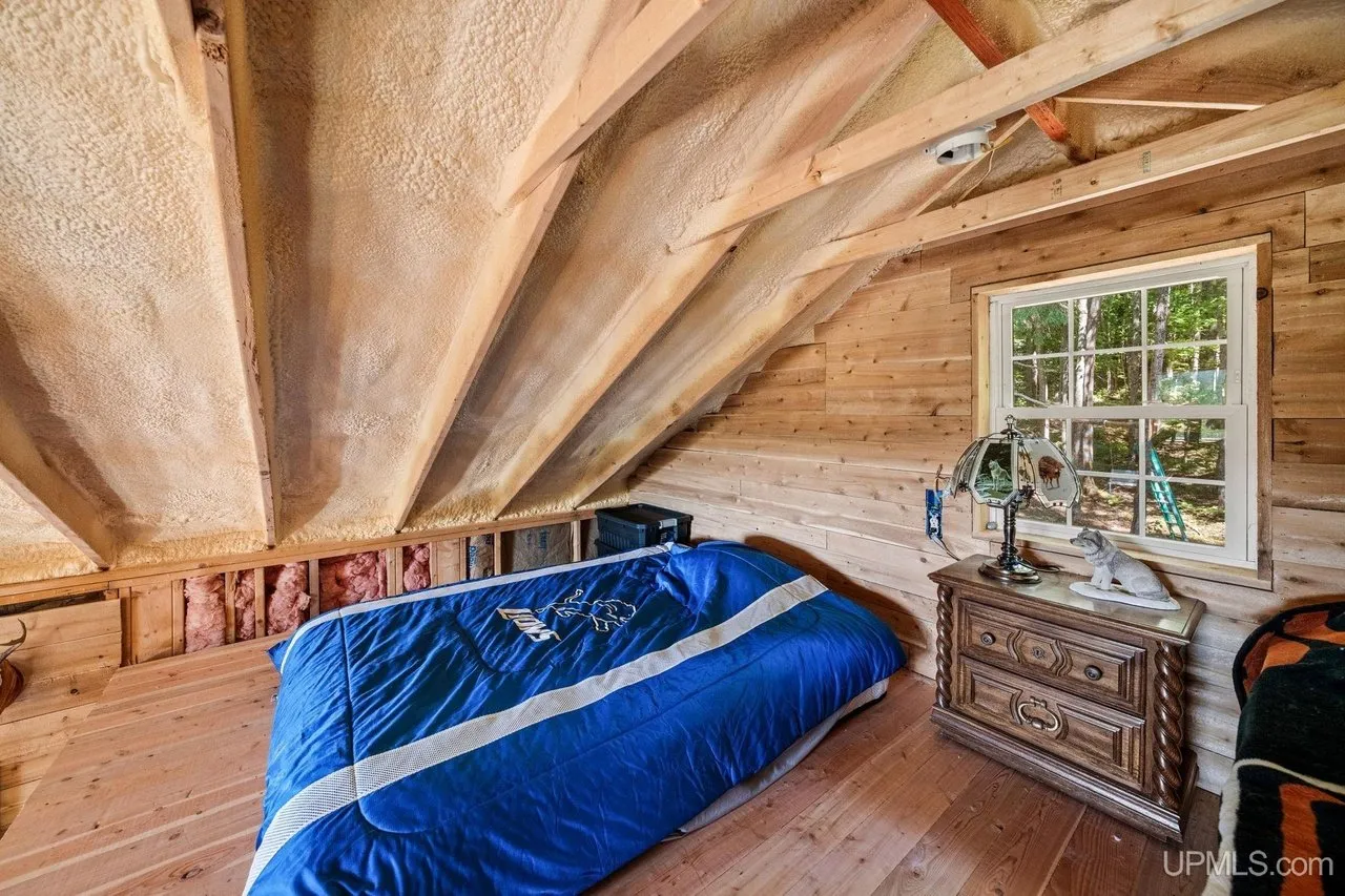 A bed in the loft under the pitched roof