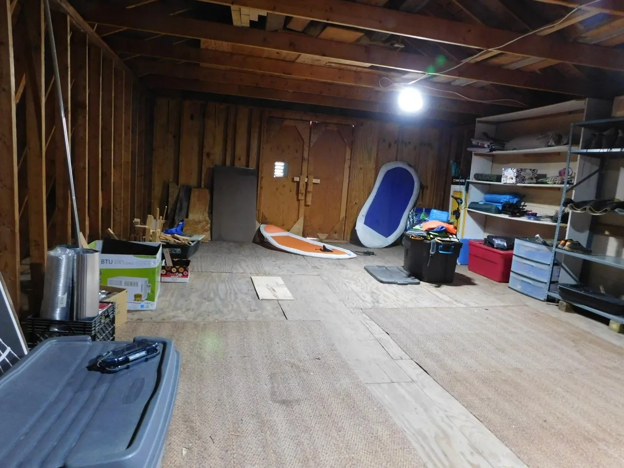 The garage lower level with a lawn tractor and storage