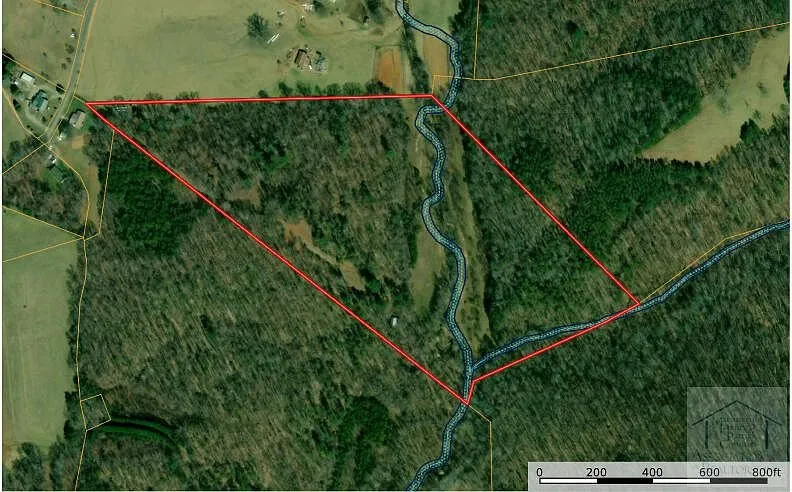 Aerial with the parcel boundary outlined over the woods