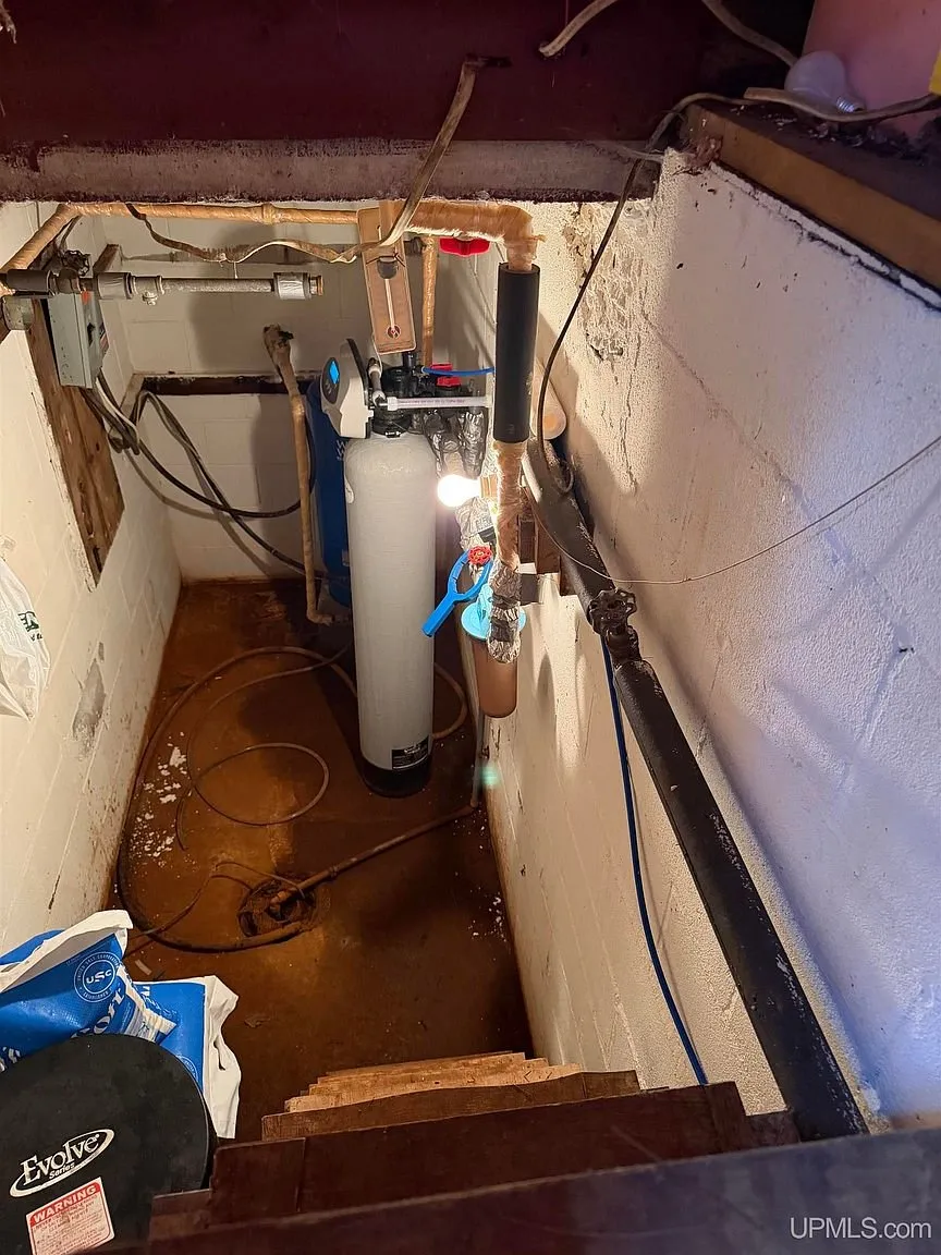 The utility space with the water heater and pressure tank