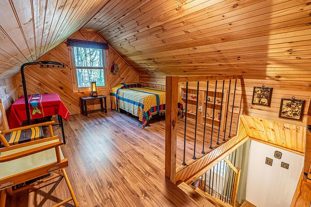 The screened porch door leading out to the walk-out balcony off the loft