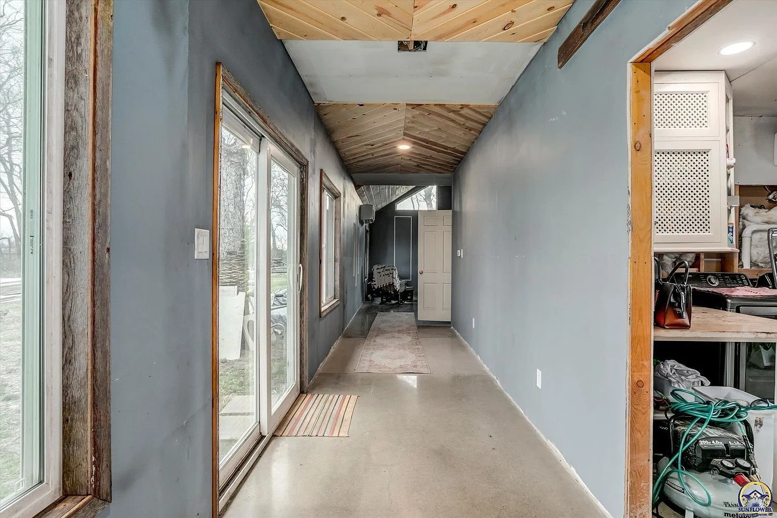 The hall in the addition with the glass door to the yard