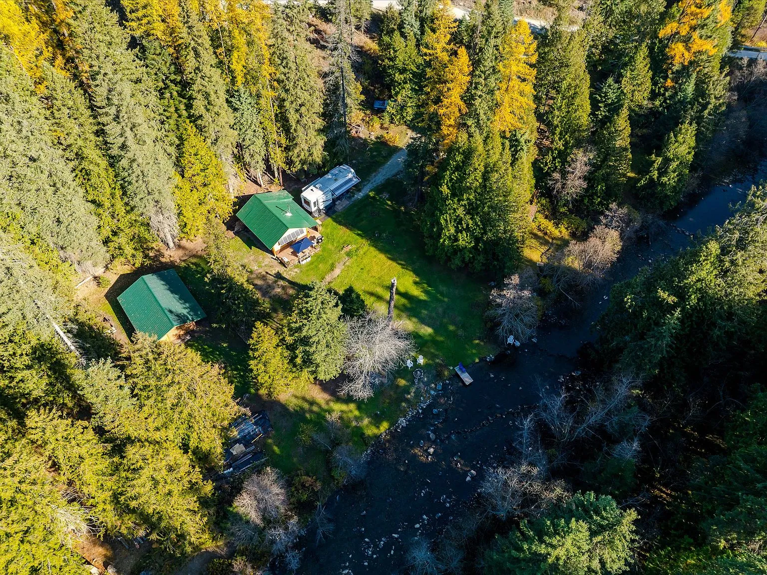 An aerial view of the cabin, porch and lawn from directly overhead
