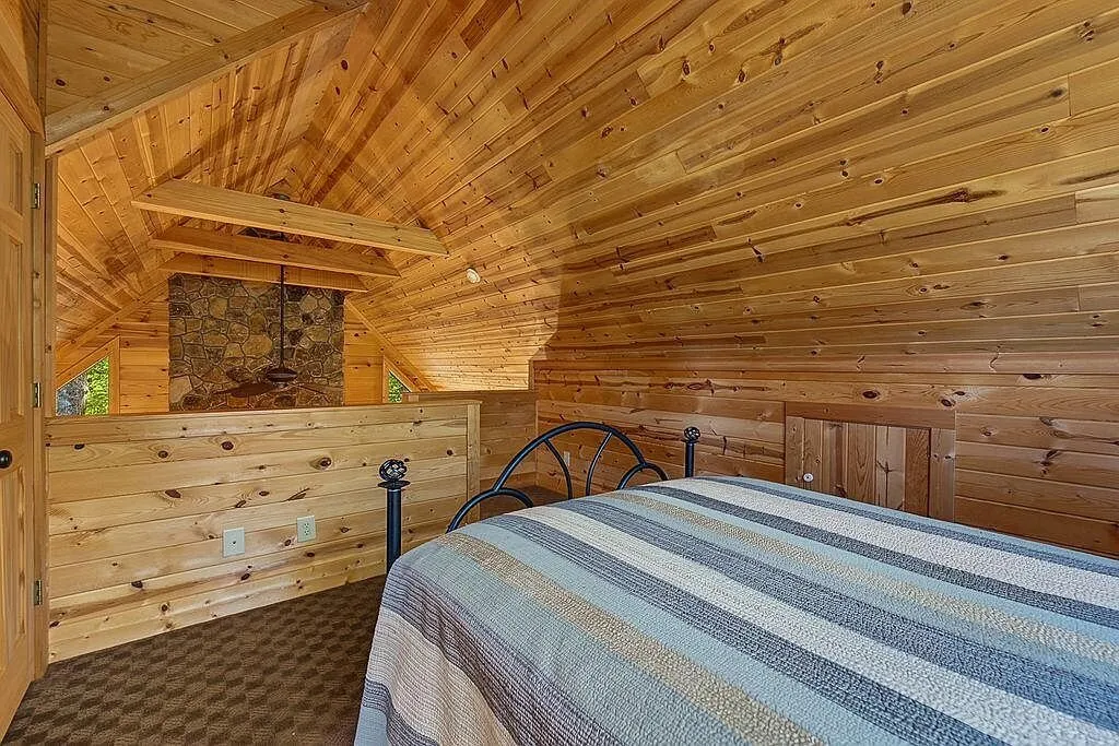 A bedroom closet door and dresser along a log wall