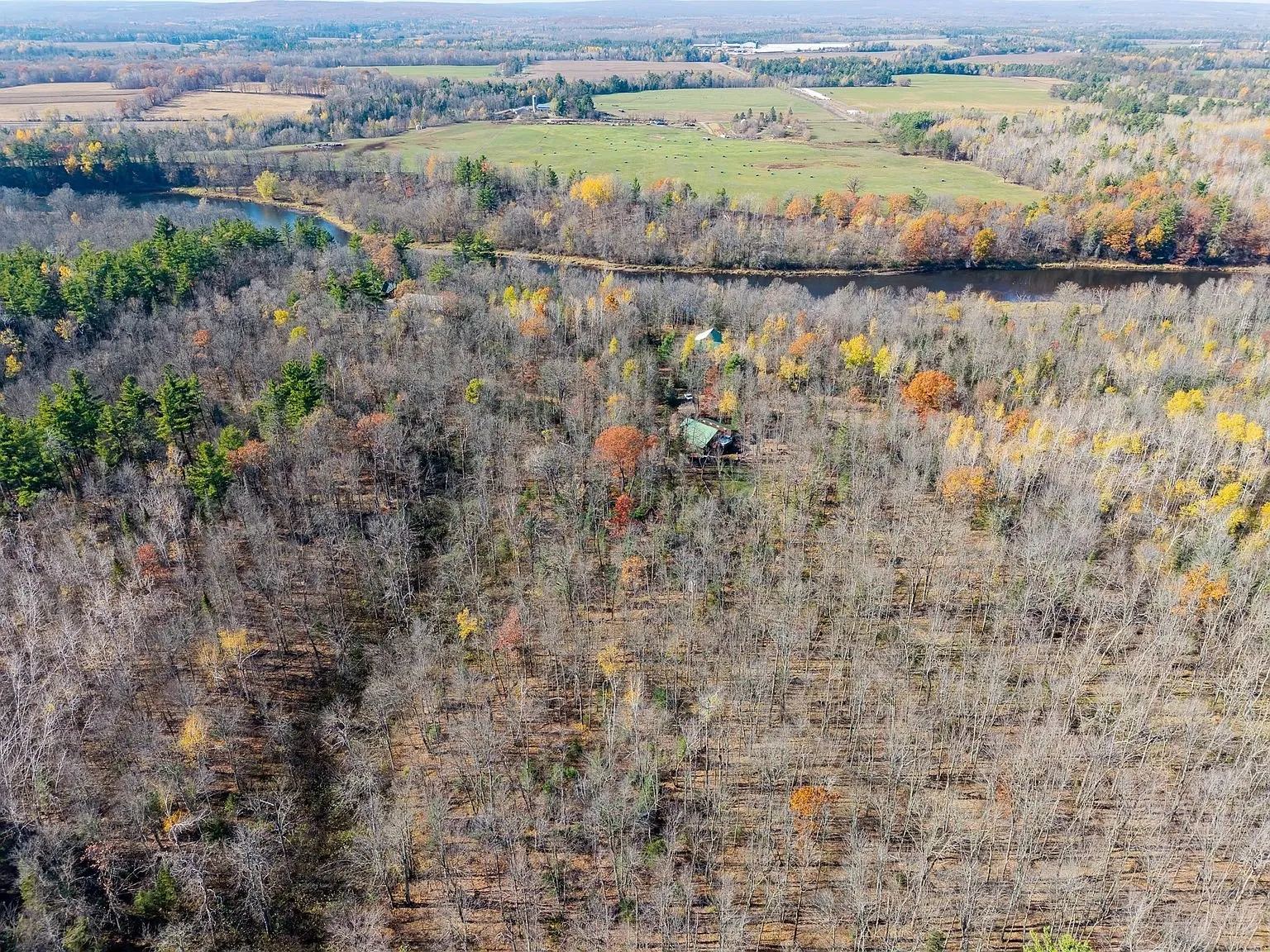 A wide aerial view of the Chippewa River bend and surrounding farmland near the property