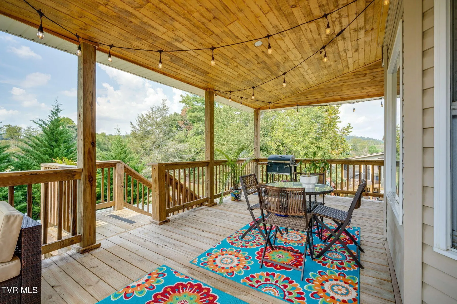 The covered deck looking out over the back yard and the trees