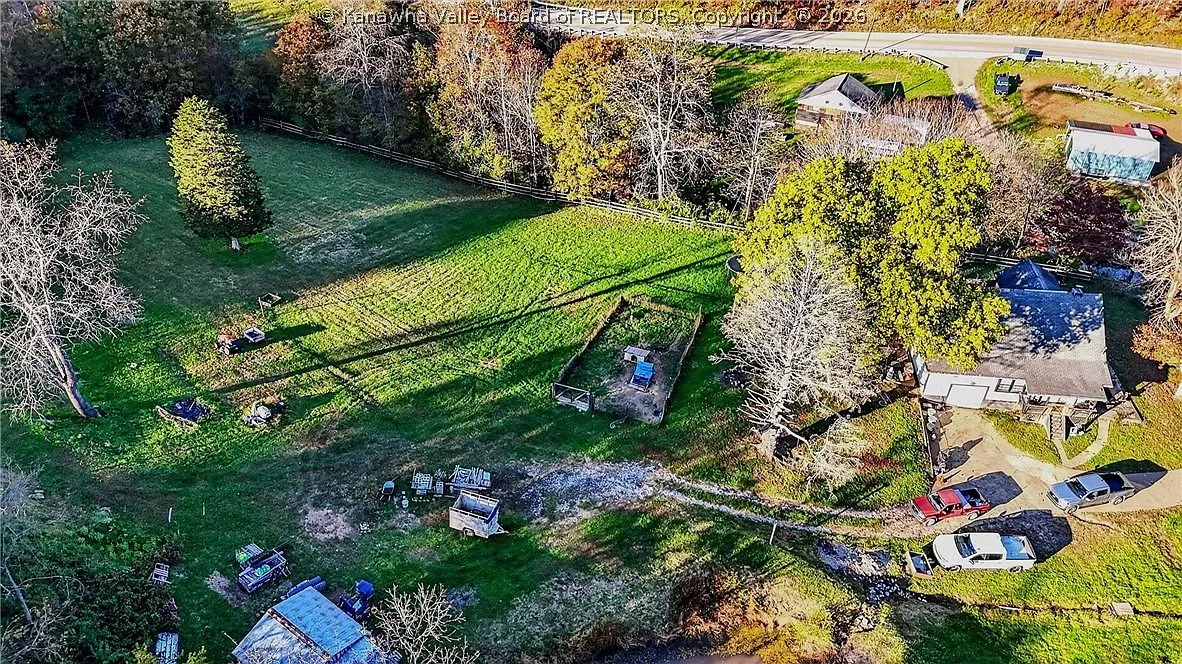 An aerial view of the house's rear addition, porch and two parked trucks