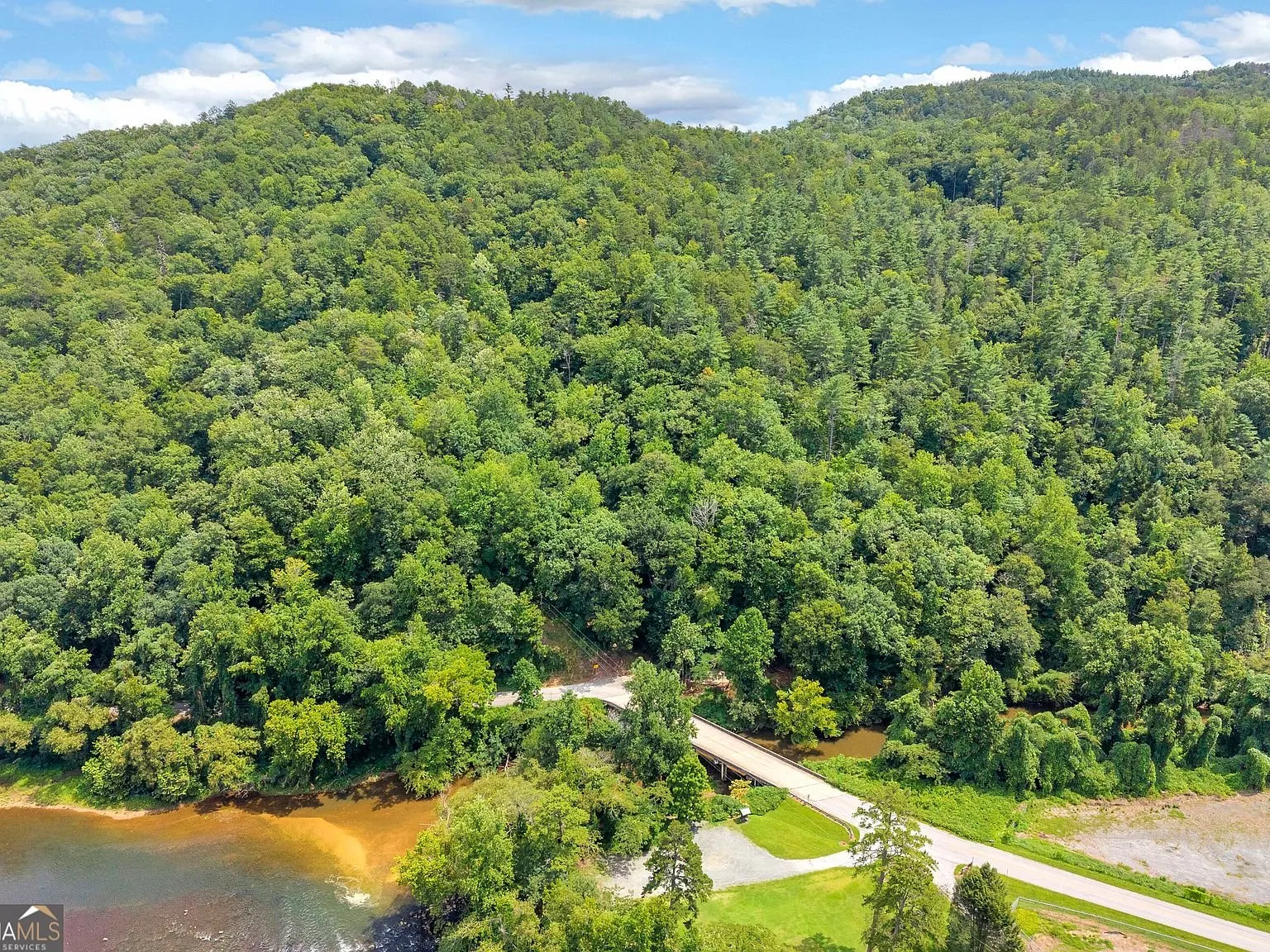 Aerial view of the river valley and roadway cutting through the forest