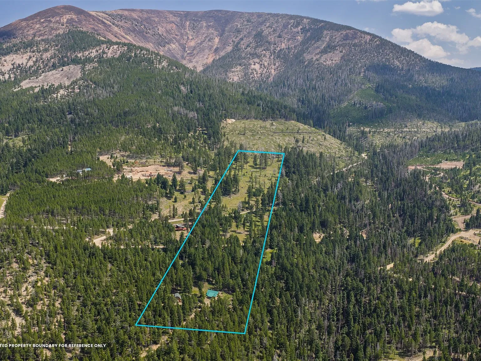 An aerial view of the property's approximate boundary outlined over the surrounding forest