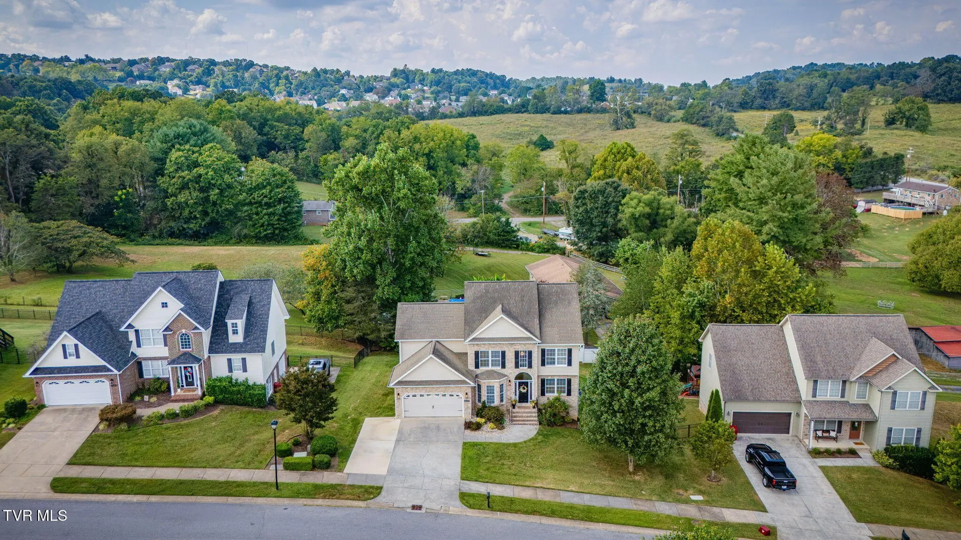 The house from the air with the back yard and deck visible