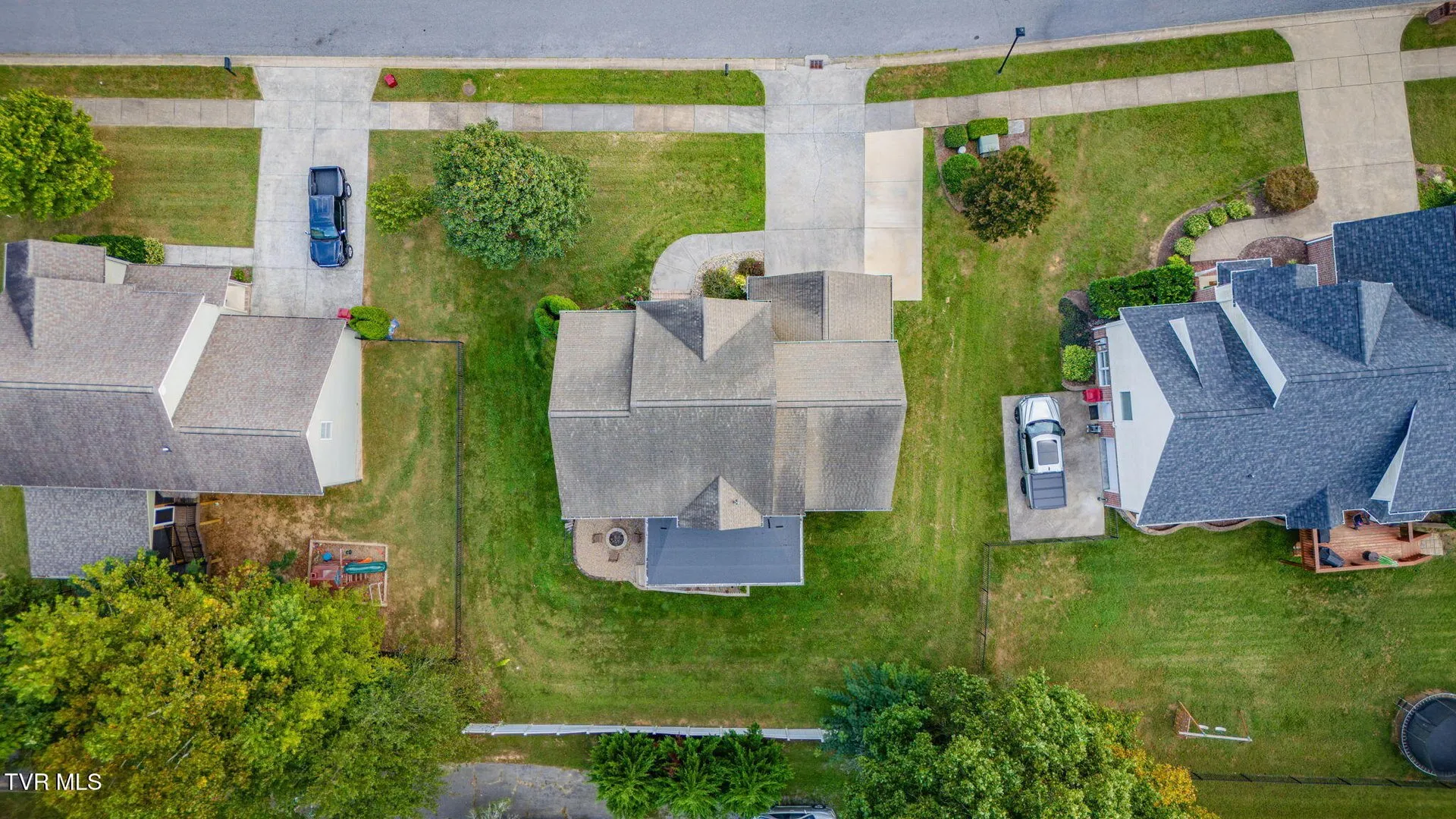 The roof and yard from directly above with the driveway and street