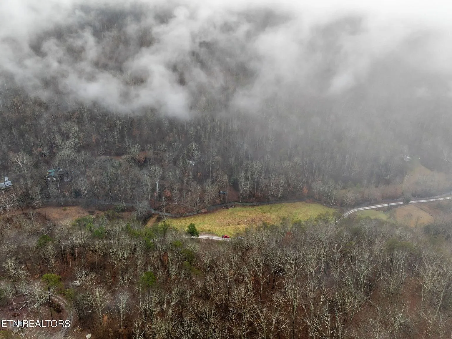 Aerial view of the property boundary outlined over the misty hillside