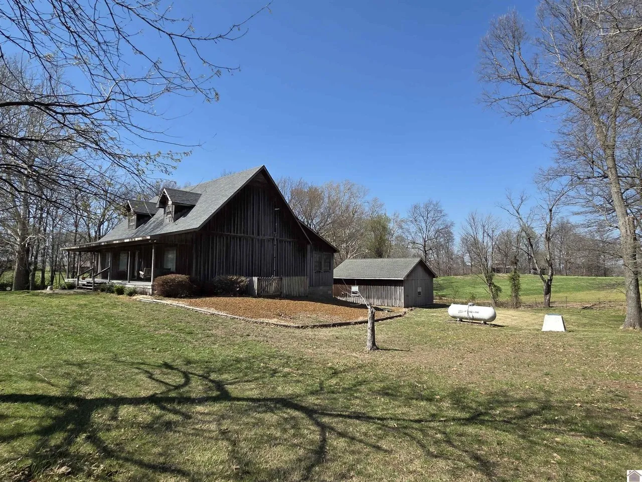 The Clinton house from the side yard, with the two detached buildings beyond it