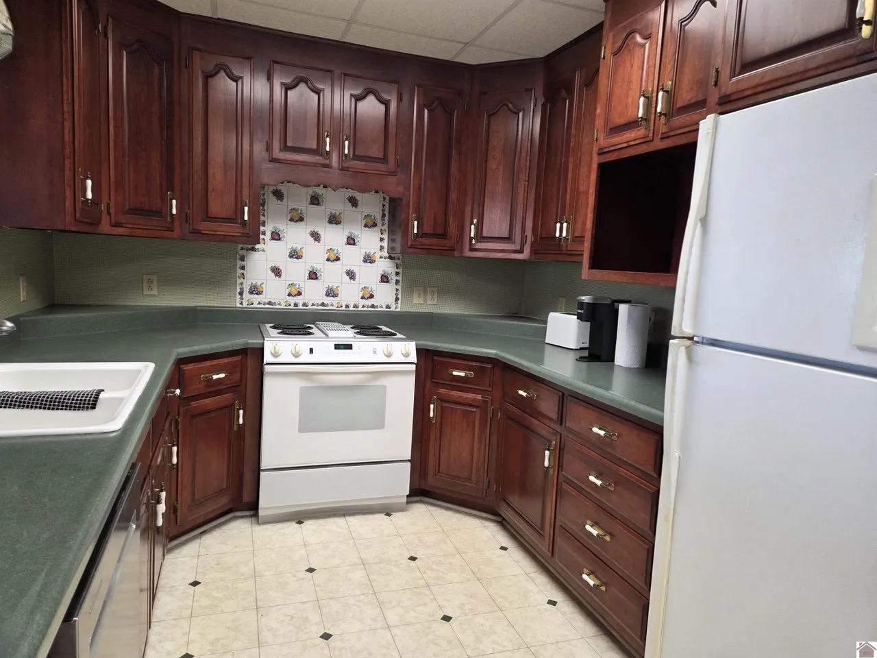 The kitchen with cherry cabinets, a skylight and a white range