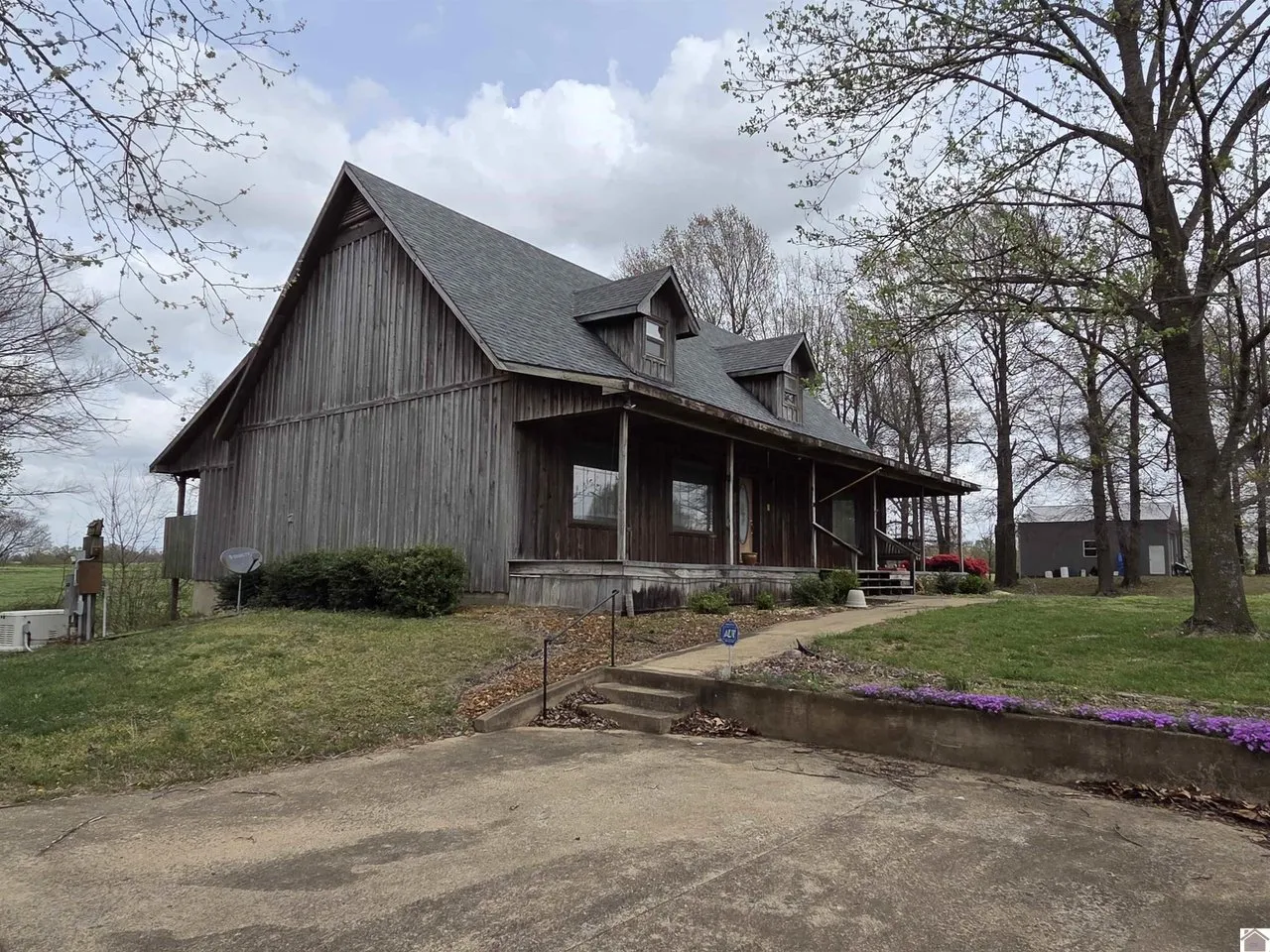 The house from the front corner, the porch running its full width