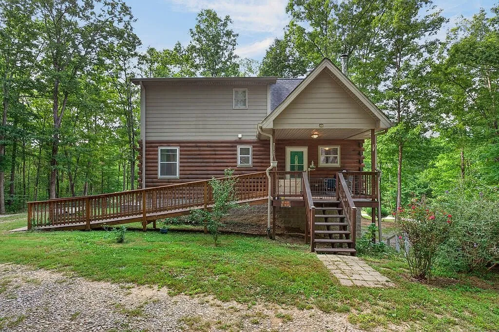 The log cabin's exterior among mature trees