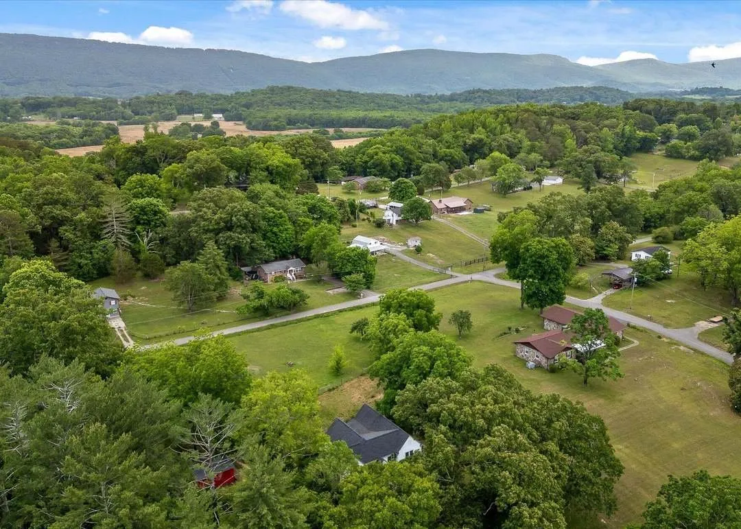 Aerial view of the home's hilltop setting overlooking the town and surrounding mountains