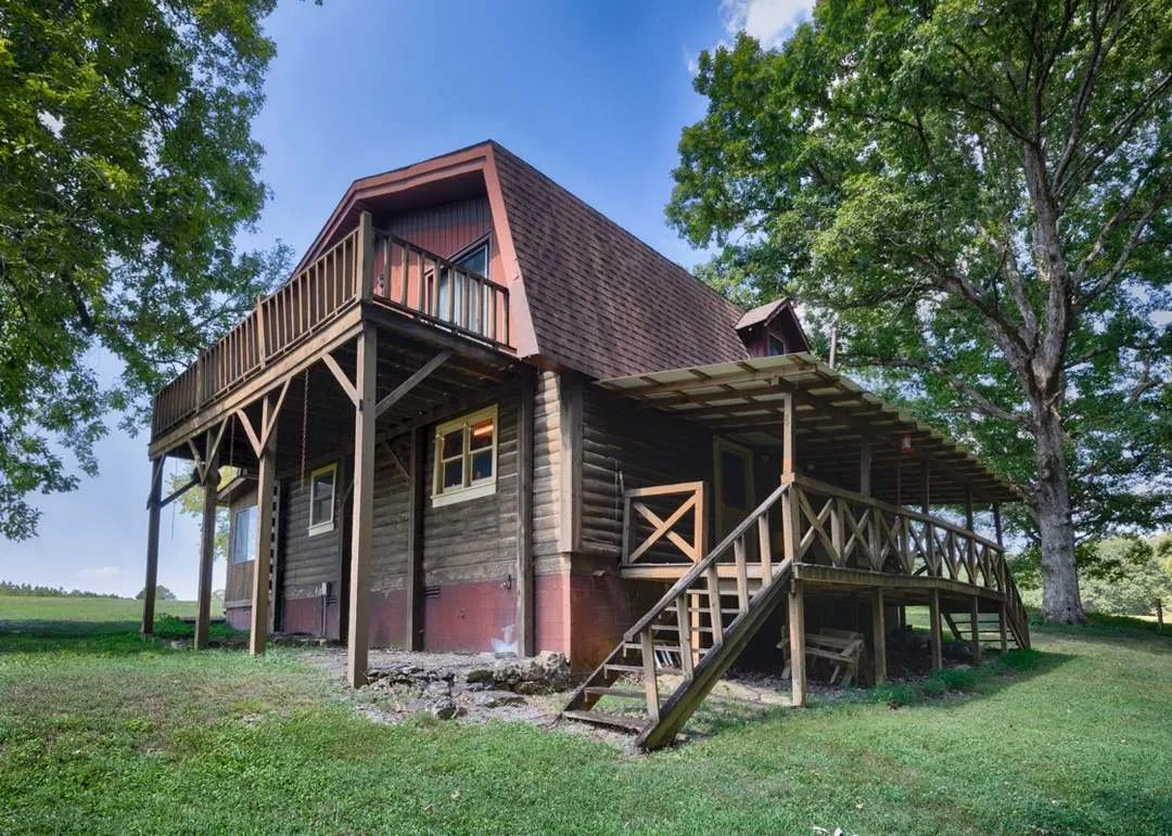 The home's exterior, a second-story deck visible above the covered lower porch