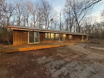 The single-level home's exterior with vertical wood siding
