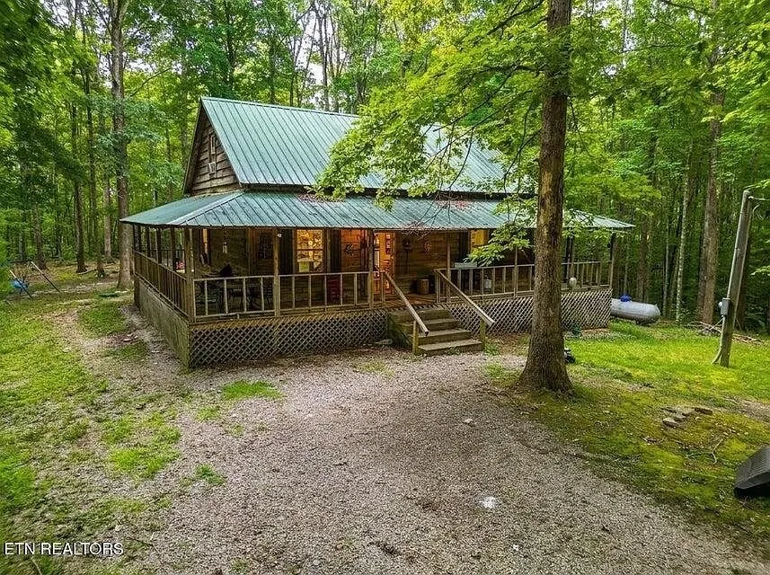 A rustic wood cabin tucked into the woods on 5.02 acres near Jamestown, Tennessee