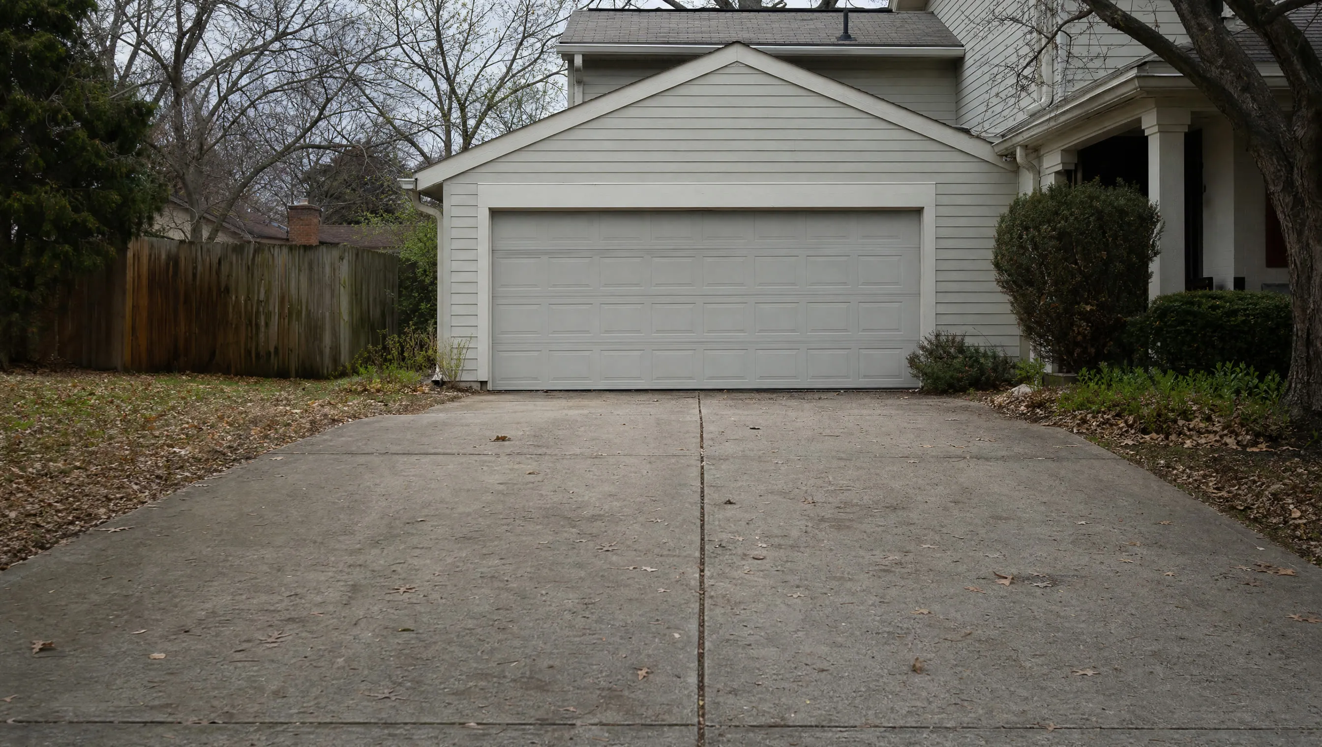 An empty driveway and closed garage