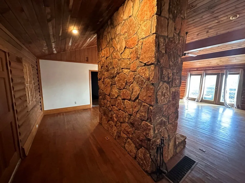 The stone chimney rising through the main room