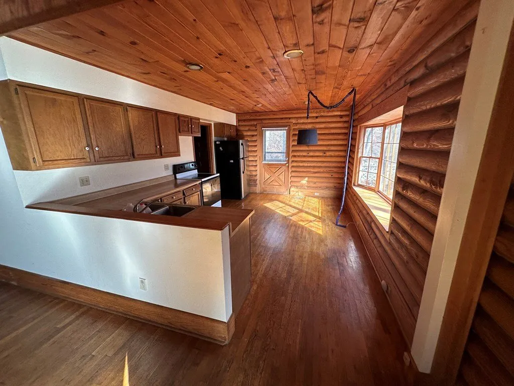 The kitchen bar and cabinets seen from the main room