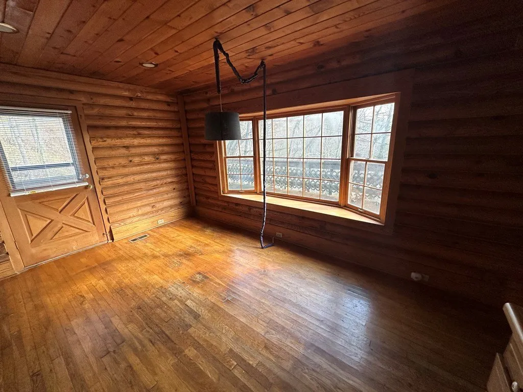 A room with wood floors and a window seat