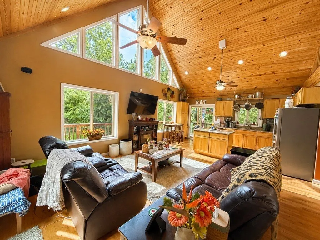 The great room from the loft side, sofas and the kitchen beyond