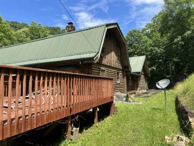 The deck along the side of the house, satellite dish on the corner