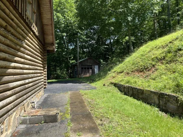 The side of the house and the detached garage up the drive