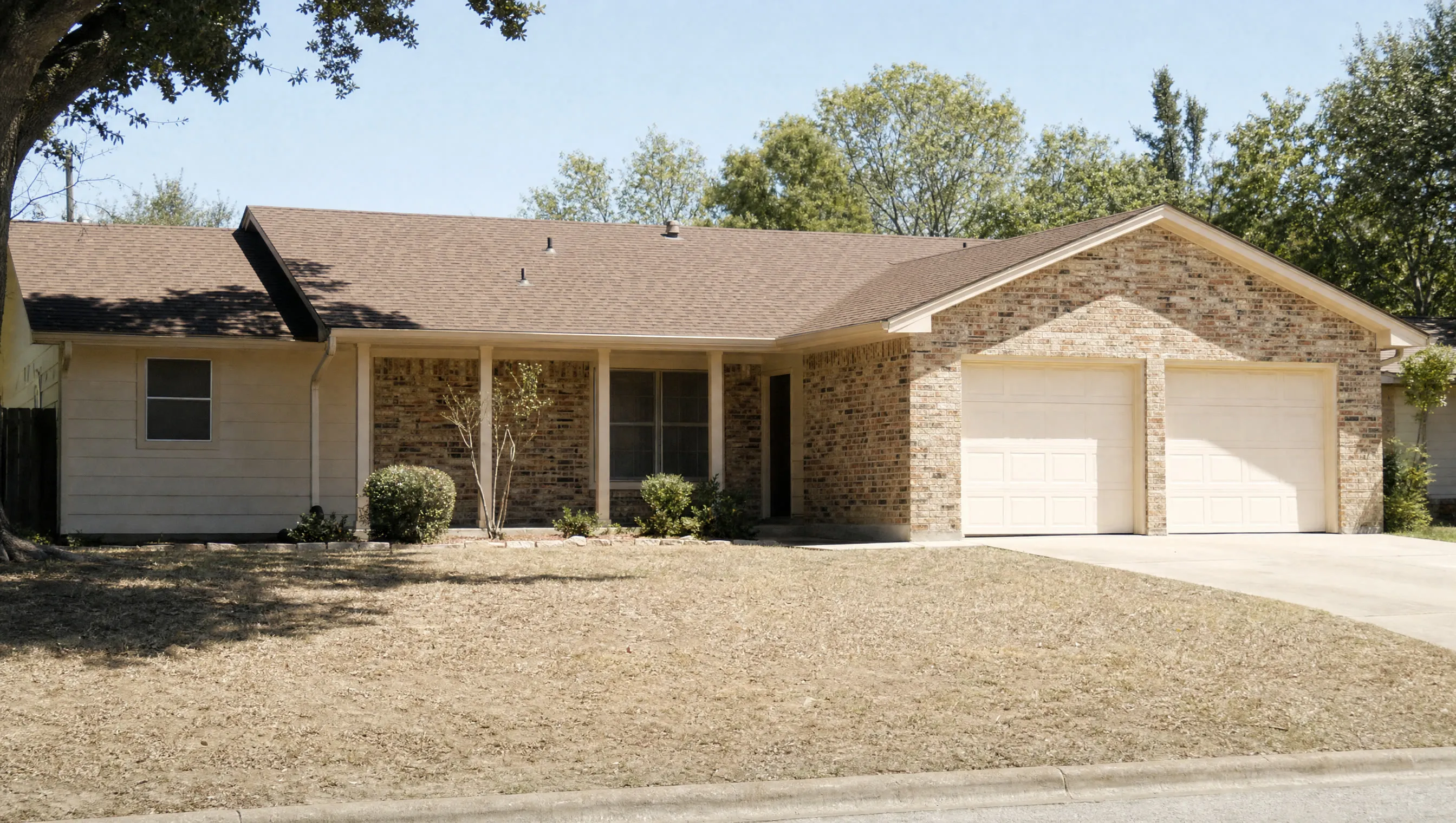 A Texas ranch-style house in hard midday light